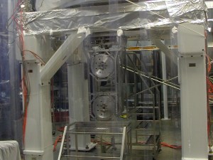 A portion of the mirror assembly at LIGO, consisting of three sections that can move like pendulums. Having three sections means the lowest portion - which the mirror itself - moves relatively little when seismic waves hit it. What remains should be (at least partly) due to gravitational waves. [Credit: moi]