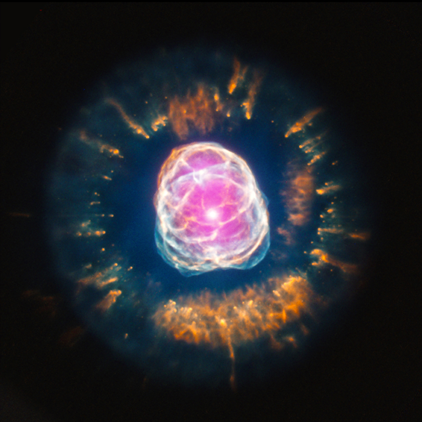 The death of a star much like our Sun is a thing of beauty. This is the nebula NGC 2392, as imaged in visible light and X-rays (the pink colors). [Credit: X-ray: NASA/CXC/IAA-CSIC/N.Ruiz et al, Optical: NASA/STScI]