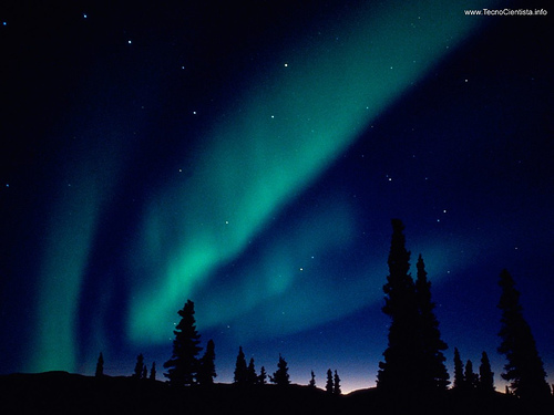 The Aurora borealis — the Northern Lights — over Alaska. The green color is emission from oxygen atoms high in the atmosphere, when charged particles from the Sun strike them. [Credit: Well_Lucio on Flickr]