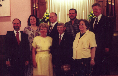 My maternal grandparents (center) at their 50th wedding anniversary, surrounded by their children, with their spouses.