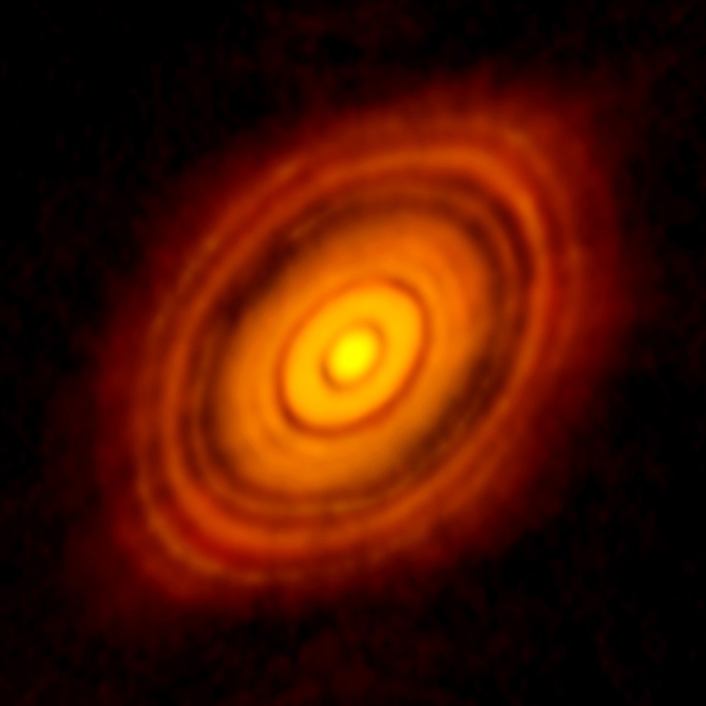An amazing view of the protoplanetary disk around the newborn star HL Tauri. The dark rings are places where new planets are forming, along with places where gravity from those planets causes ripples in the debris. [Credit: ALMA (NRAO/ESO/NAOJ); C. Brogan, B. Saxton (NRAO/AUI/NSF)]